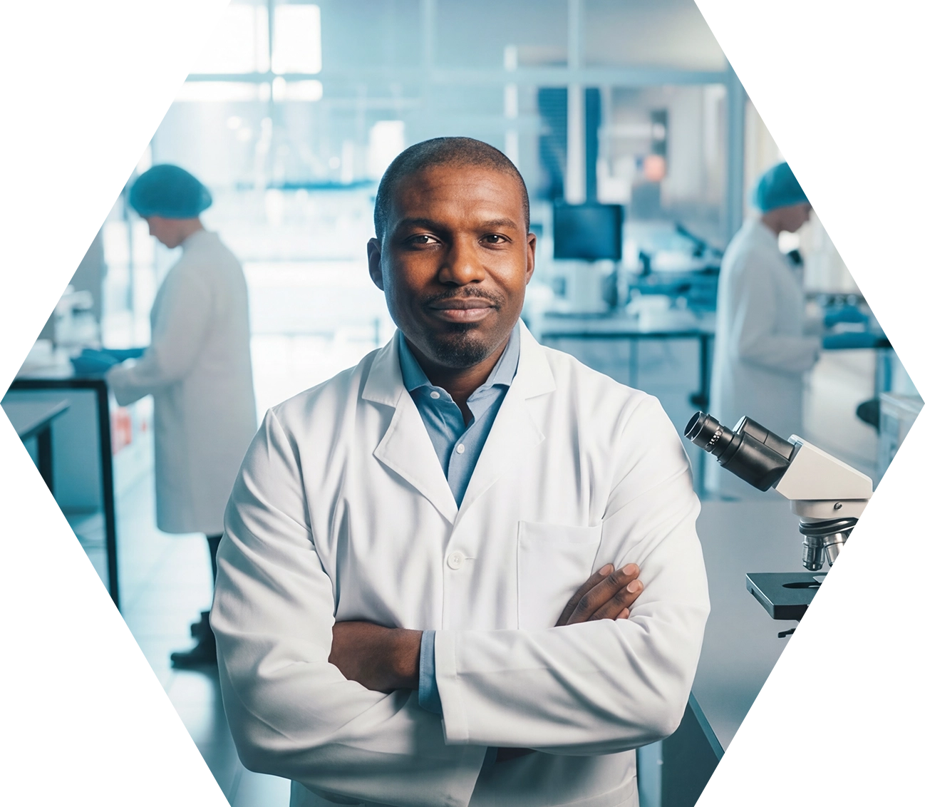 A confident scientist in a white lab coat stands with arms crossed in a modern laboratory, with two colleagues working in the background and a microscope on the table nearby.