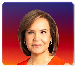 A woman with straight, shoulder-length brown hair, wearing hoop earrings and a sleeveless red top, is smiling slightly in front of a gradient background of purple, pink, and orange.